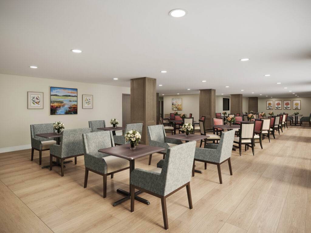 Bright dining room with comfortable seating, floral centerpieces, and artwork creating a welcoming space.