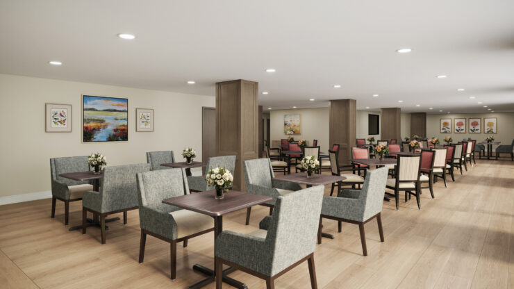 Bright dining room with comfortable seating, floral centerpieces, and artwork creating a welcoming space.