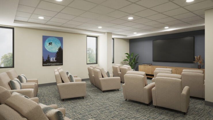 Comfortable seating arranged theater-style around a large screen promotes shared entertainment and connection.