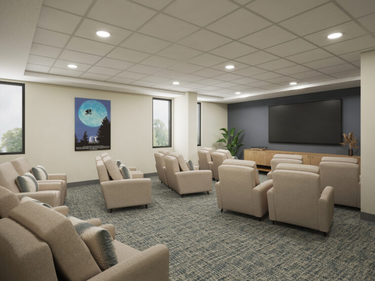 Comfortable seating arranged theater-style around a large screen promotes shared entertainment and connection.