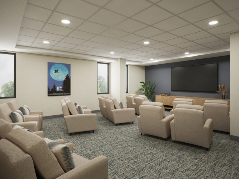 Comfortable seating arranged theater-style around a large screen promotes shared entertainment and connection.