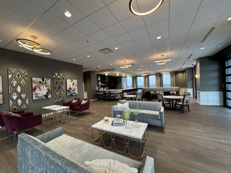 Spacious lounge with comfortable seating, modern lighting, and large windows creating a welcoming community space.