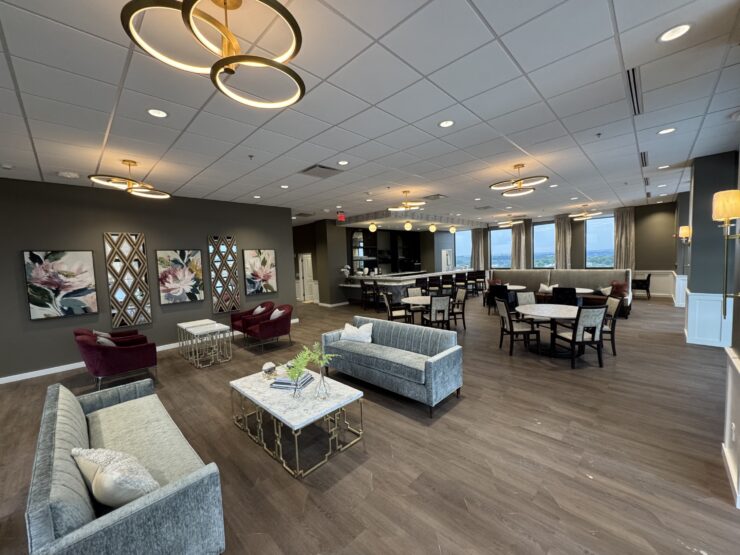 Spacious lounge with elegant seating, warm lighting, and large windows fostering community connections.