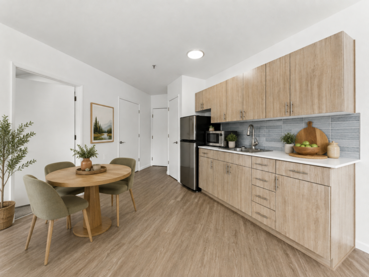 Bright, inviting kitchen and dining area with wood finishes and natural decor fostering community warmth.