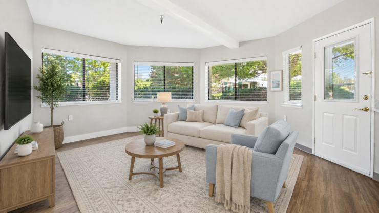 Bright living room with comfortable seating, natural light, and a welcoming atmosphere.