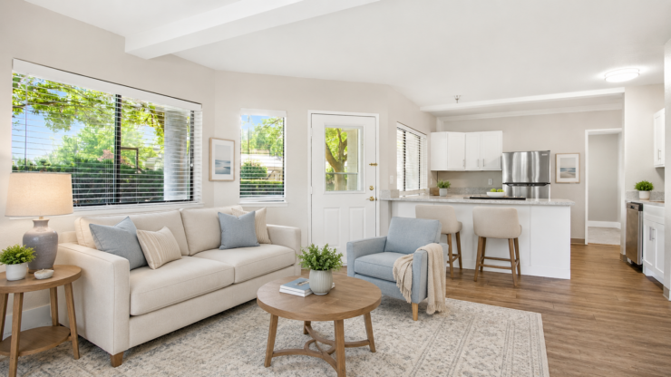 Bright, inviting living space with comfortable seating and a connected kitchen area.