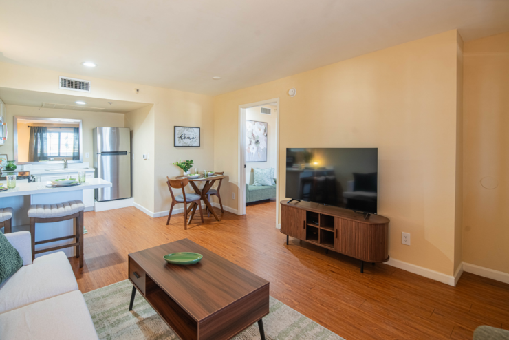 Bright, inviting apartment with open kitchen, dining area, and comfortable living space fostering community.