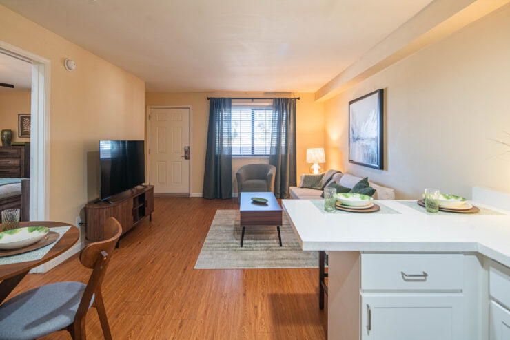 Inviting living area with seating, dining space, and natural light for comfortable community living.