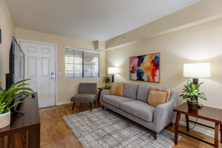 Bright and welcoming lounge with comfortable seating and vibrant artwork for relaxing gatherings.