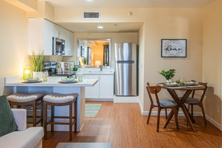 Bright and inviting kitchen and dining area with modern amenities and warm wood flooring.
