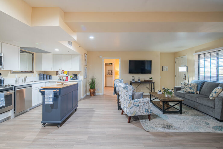 Spacious living area with kitchen and comfortable seating designed for relaxed community living.