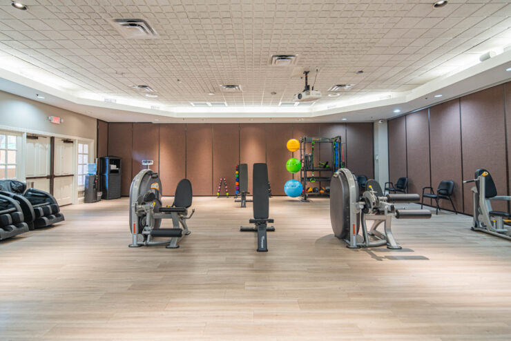 Well-lit fitness room with exercise equipment promoting health and community engagement.