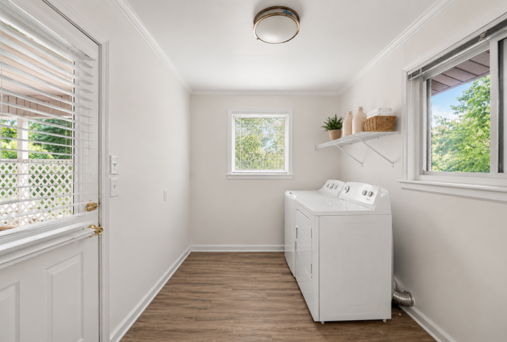 Bright and tidy laundry room with washer, dryer, and natural light creating a welcoming space.