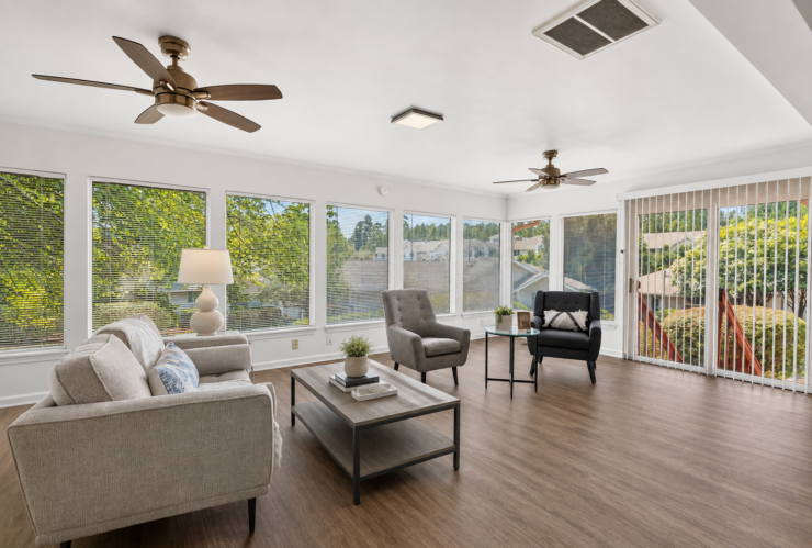 Bright, inviting lounge with comfortable seating and large windows overlooking greenery.