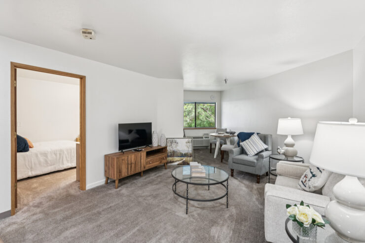 Bright living area with comfortable seating, natural light, and a welcoming dining space.