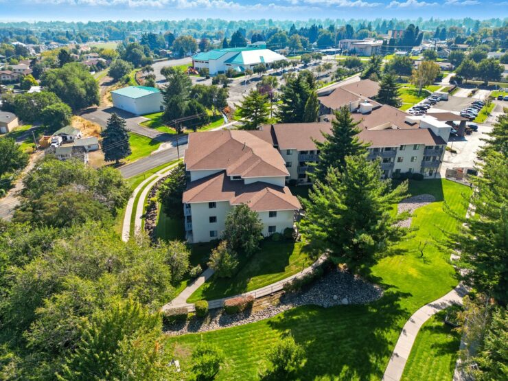 Retirement community surrounded by lush greenery and well-maintained walking paths.