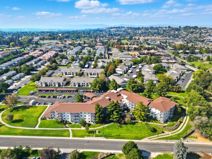 Well-maintained residential community with green lawns and walking paths set against a peaceful neighborhood backdrop.