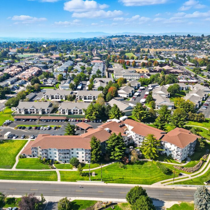 Well-maintained residential community with green lawns and walking paths set against a peaceful neighborhood backdrop.