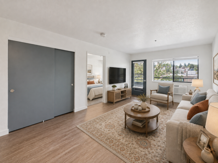Bright, inviting living space with comfortable seating and natural light, promoting a welcoming community feel.