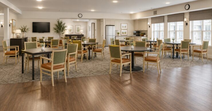 Bright and welcoming activity space with ample seating, natural light, and homey decor.