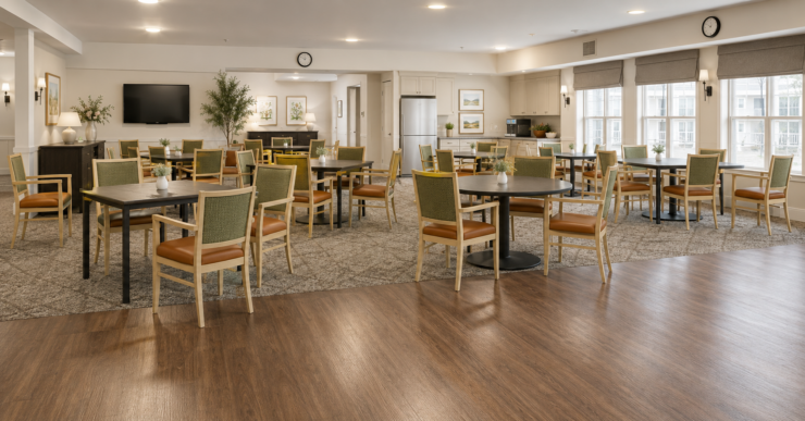 Bright and spacious activity room with comfortable seating and natural light for social gatherings.