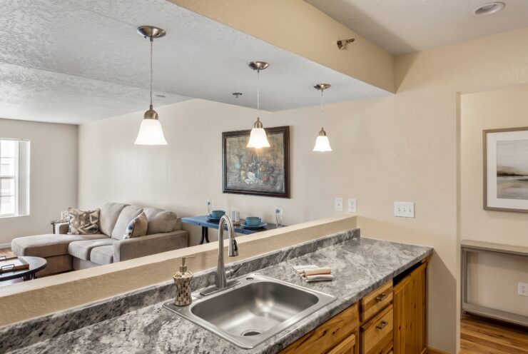 Open kitchen and living area with comfortable seating and warm, inviting lighting.