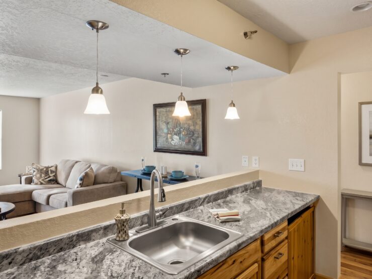 Open kitchen and living area with comfortable seating and warm, inviting lighting.
