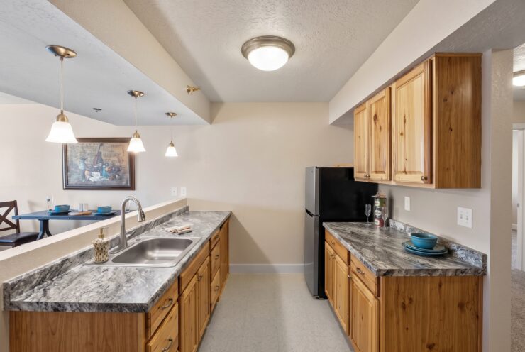 Warm, inviting kitchen with natural wood cabinetry and comfortable dining area for shared meals.