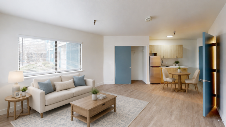 Bright and inviting living space featuring comfortable seating, dining area, and modern kitchen.