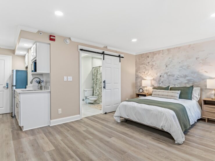 Bright, inviting living space with modern kitchen, comfortable bed, and accessible bathroom.