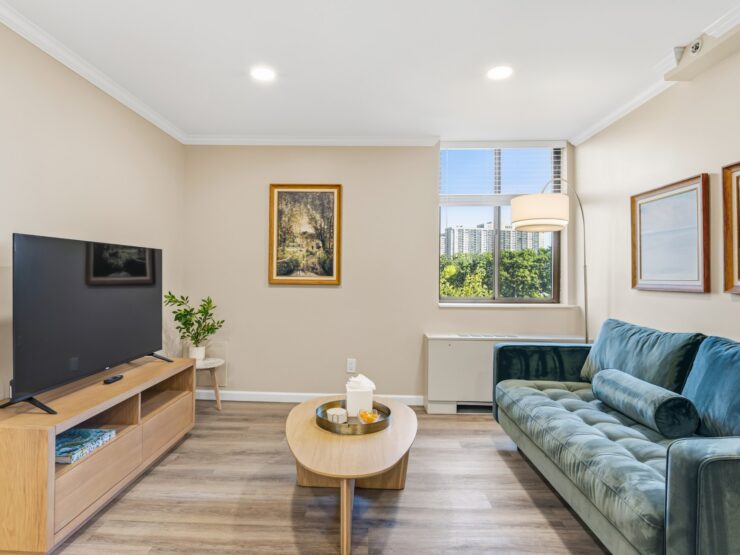 Bright living area with comfortable seating, natural light, and inviting artwork.