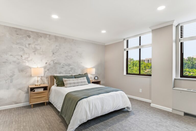 Bright and welcoming bedroom with nature views, soft lighting, and calming neutral tones.