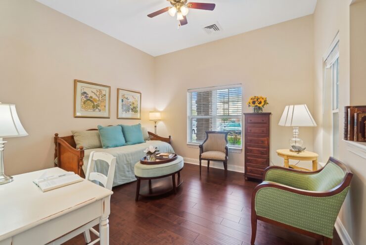 Comfortable living room with soft lighting, inviting seating, and natural light through windows.