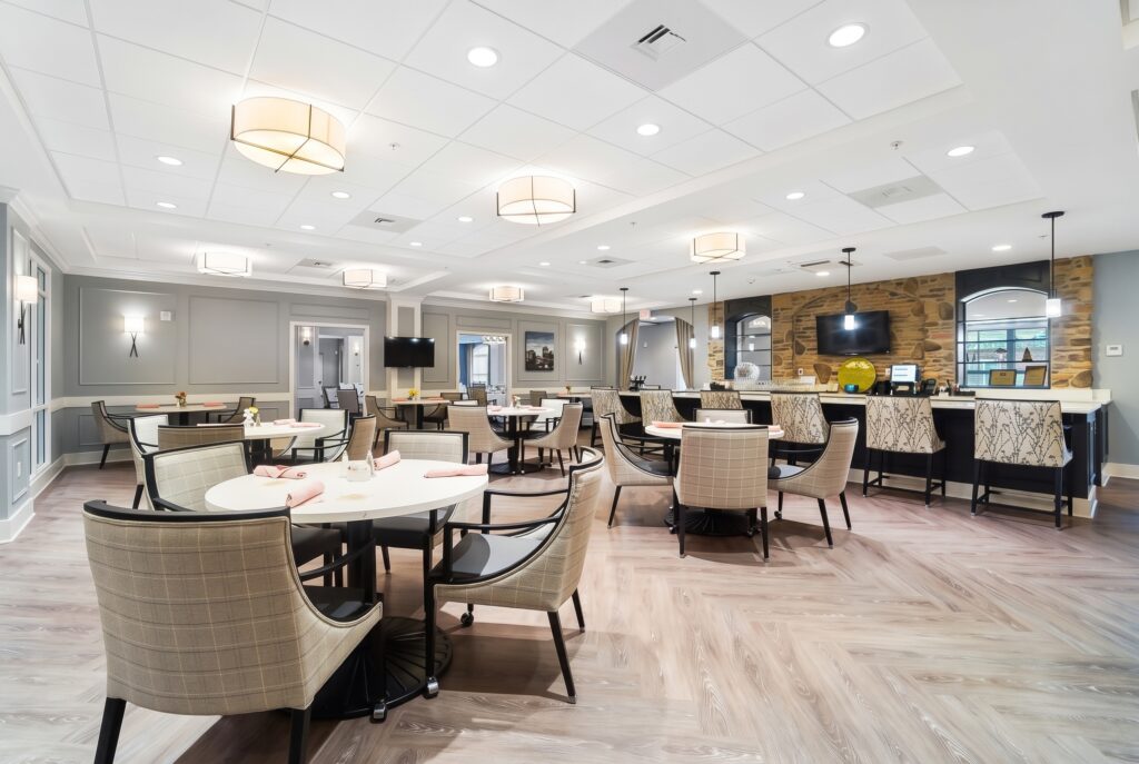 Bright, inviting dining area with comfortable seating and a warm, welcoming atmosphere for residents.