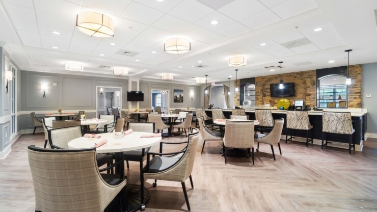 Bright, inviting dining area with comfortable seating and a warm, welcoming atmosphere for residents.
