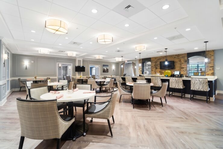 Bright, inviting dining area with comfortable seating and a warm, welcoming atmosphere for residents.