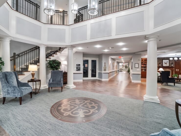 Bright, elegant retirement home foyer with comfortable seating, tasteful decor, and inviting community spaces.