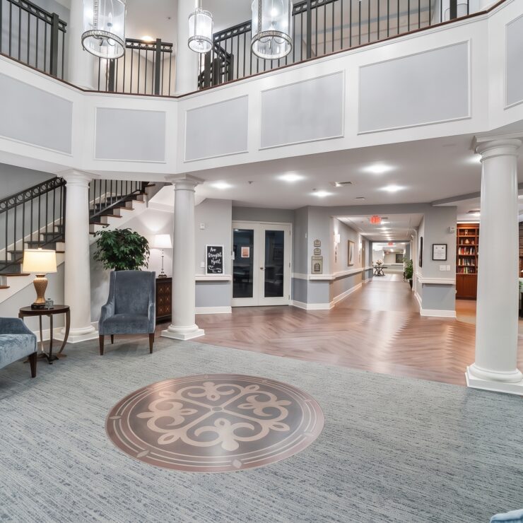 Bright, elegant retirement home foyer with comfortable seating, tasteful decor, and inviting community spaces.