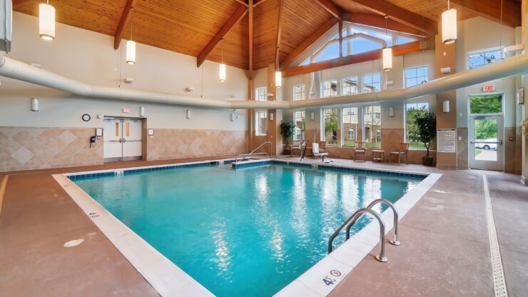 Indoor pool area with natural light, comfortable seating, and a welcoming community space.