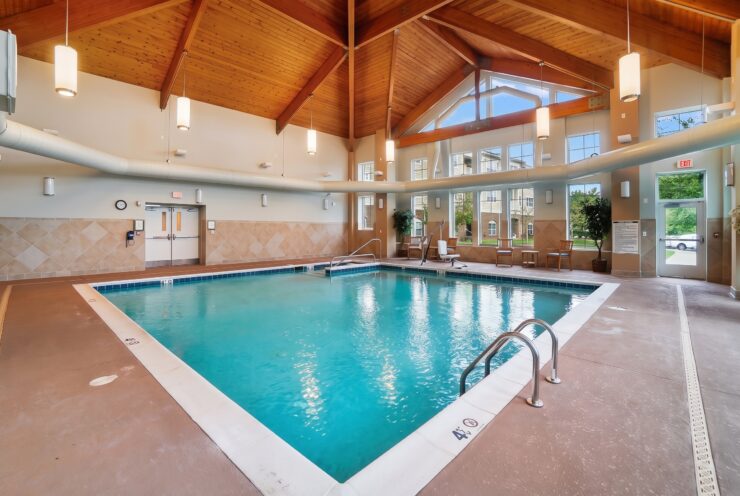 Indoor pool area with natural light, comfortable seating, and a welcoming community space.