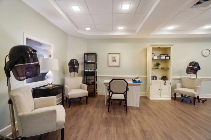 Well-lit salon with comfortable chairs and hair dryers, perfect for relaxing community care.