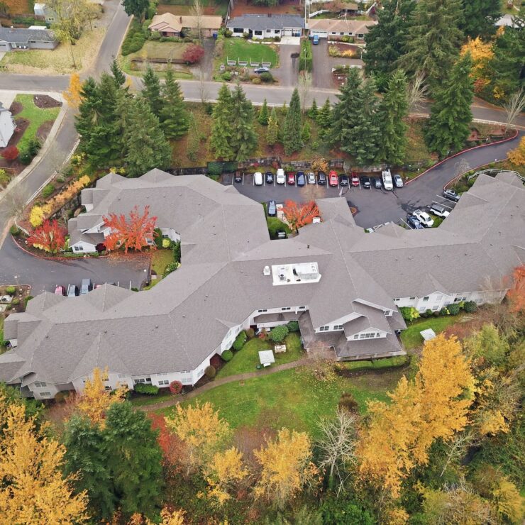 Retirement home surrounded by trees and peaceful landscaping in a friendly neighborhood.