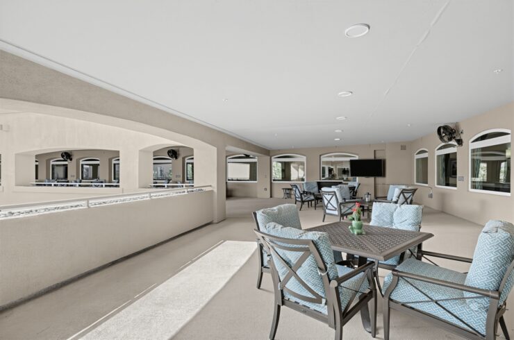 Bright and airy seating area with comfortable chairs and tables, perfect for social gatherings.