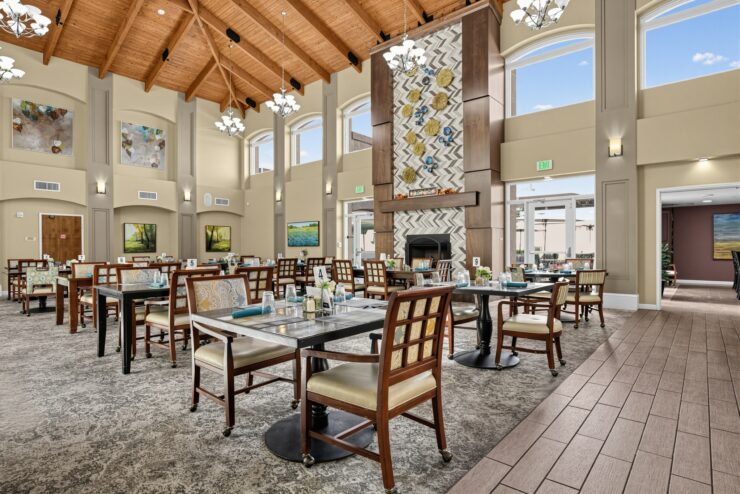 Bright dining room with wooden ceilings, elegant decor, and welcoming seating for community meals.