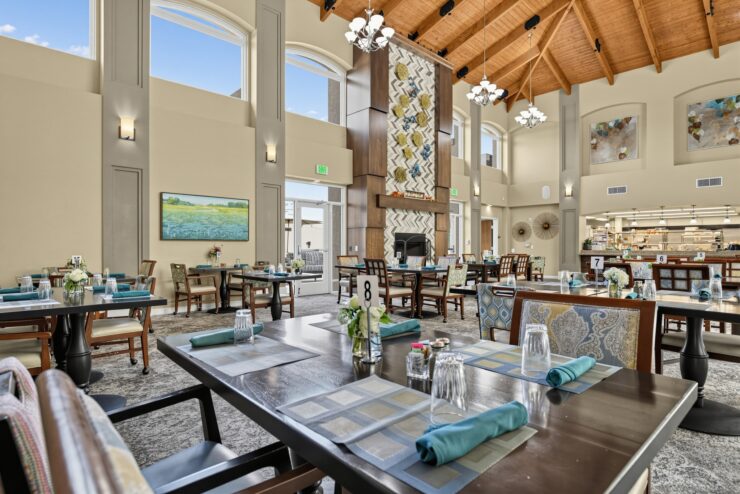 Spacious dining area with natural light, elegant decor, and inviting seating for community meals.