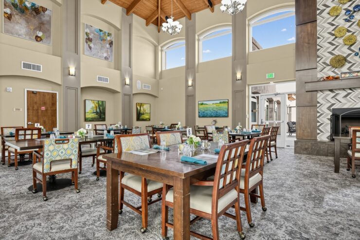 Spacious dining room with natural light, comfortable seating, and a welcoming atmosphere for residents.