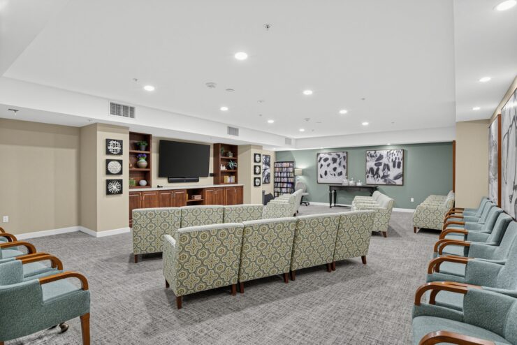 Spacious lounge with comfortable seating, TV, and warm decor for social gatherings.