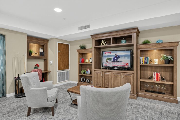Bright, inviting lounge with comfortable seating and a TV set in a warm, communal space.