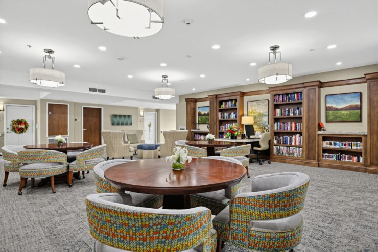 Bright and welcoming common area with comfortable seating and bookshelves for socializing and relaxation.