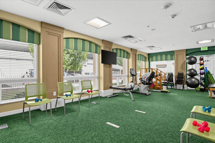 Bright exercise room with equipment and seating designed for senior wellness and social activities.